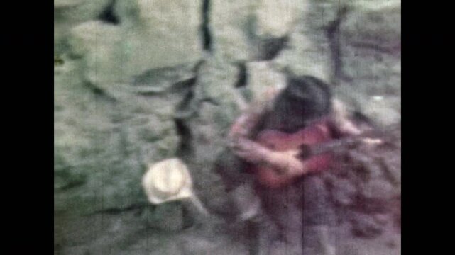 Cowboys looking for pirate treasure, digging, playing guitar in canyon cave. Adventure in treasure hunters. Discover of explore secret treasure vault. Vintage color film. Retro 1960s old archive