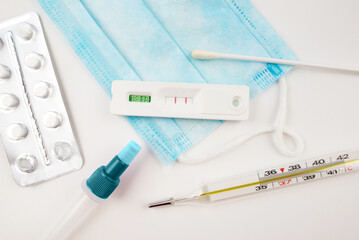 positive covid test and different pills. Coronavirus concept.