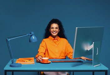 Young woman graduate in vibrant monochromatic home office