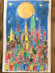 Charming Child's Artwork Depicts a Team of Superheroes Saving the City Under a Shining Moon, Drawn on White Paper on a Wooden Table