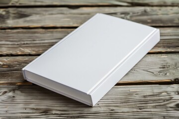Fototapeta premium A white book is sitting on a wooden table