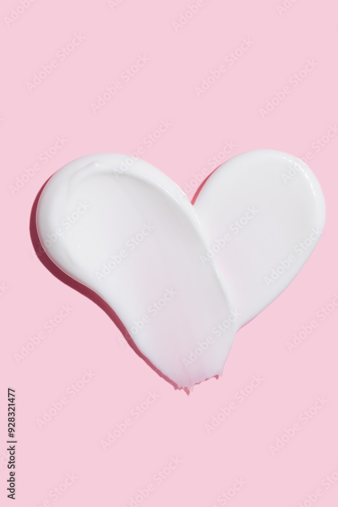 Poster cosmetic smear of creamy texture in shape of heart on pink background. body lotion skincare. face cream cosmetic product smear swatch