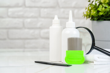 Green Comb on a Countertop with Lice Treatment Products
