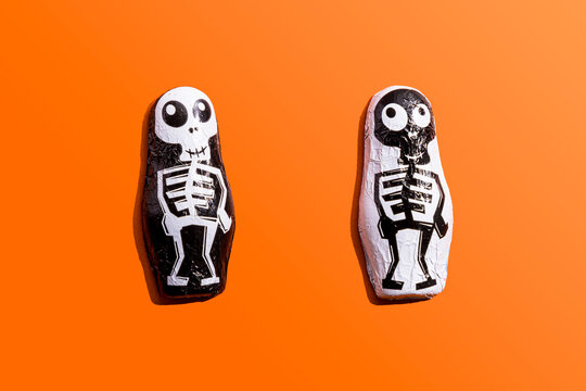 Halloween candy with skeleton wrapping against orange background