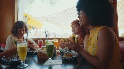 Cinematic footage about a group of multi-ethnic friends eating and having fun in an american styled diner restaurant.