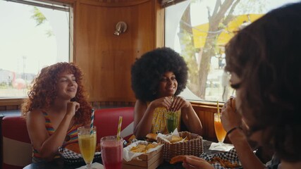 Cinematic footage about a group of multi-ethnic friends eating and having fun in an american styled diner restaurant.