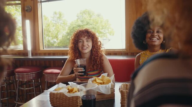 Cinematic footage about a group of multi-ethnic friends eating and having fun in an american styled diner restaurant.