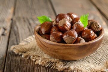 Chestnuts in wooden bowl on wooden floor