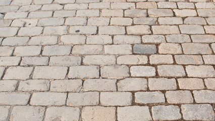Old grey coloured cobblestone floor with rectangular shape