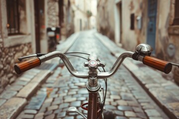 Close up of old bike handlebar in narrow street vintage toned photo