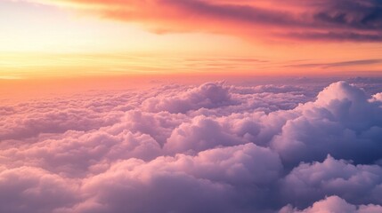 Scenic horizon filled with light clouds glowing in the orange and pink hues of twilight, ideal for serene visuals