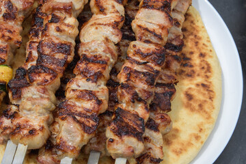 Top view of grilled kebab close up on round lavash. List of items