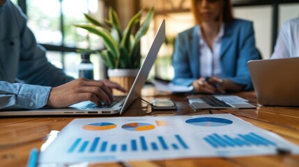 A tech startup team conducting a market research session with charts and data