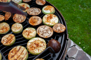 The cook prepares grilled vegetables, grilled zucchini, barbecue. Photo of food.