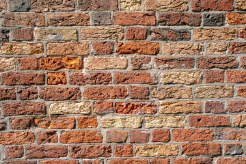 Red brick wall texture background with weathered bricks, cement joints, and an aged, grungy...