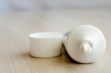 Open tube of cream. Close-up, selective focus.