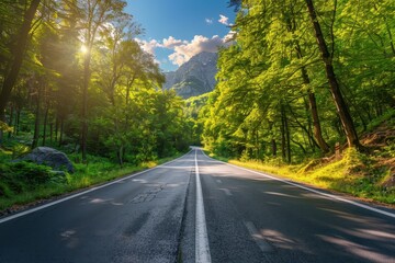 Fototapeta premium Scenic summer road through Italian forest at sunset with mountains trees and sunlight Empty asphalt road in woodland with blue sky and rock