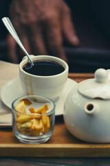 cup of black coffee and cracker with dramatic tone