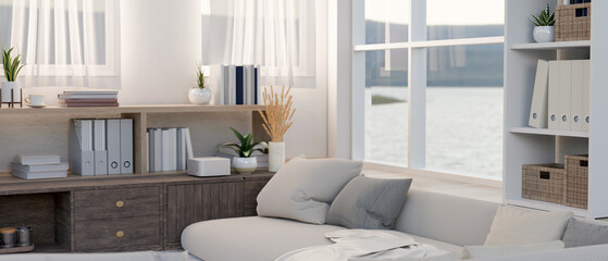 The interior design of a modern comfortable living room features a light grey sofa by the window.