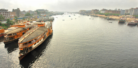 Fototapeta premium The Buriganga River flowing through the capital of Bangladesh, the city of Dhaka