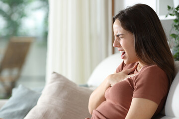 Stressed woman choking trying to breath at home