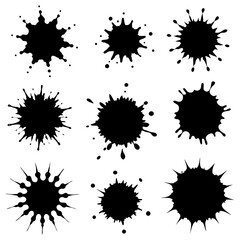 There is a collection of black ink splashes arranged on a white background