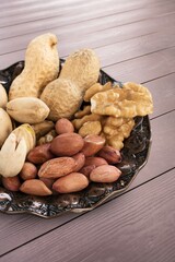 Tasty healthy mixed nuts on wooden desk