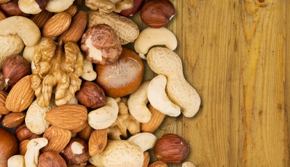 Tasty healthy mixed nuts on wooden desk
