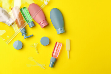 Travel Size Bottles And Containers in a bag On A Yellow Background