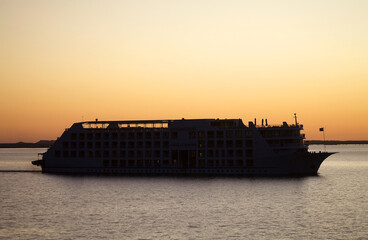 Obraz premium Lake Nasser cruise ship from Abu Simbel to Aswan at sunset, Egypt