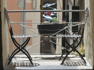 Two chairs around a table in Bordighera Alta, Italy
