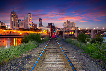 Fototapeta premium Saint Paul, Minnesota, USA. Cityscape image of downtown St. Paul, Minnesota, USA with railway tracks leading to the city at beautiful summer sunset.