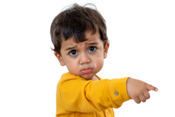 A little boy with tears in his eyes, pointing at something with a disappointed look on a white background.