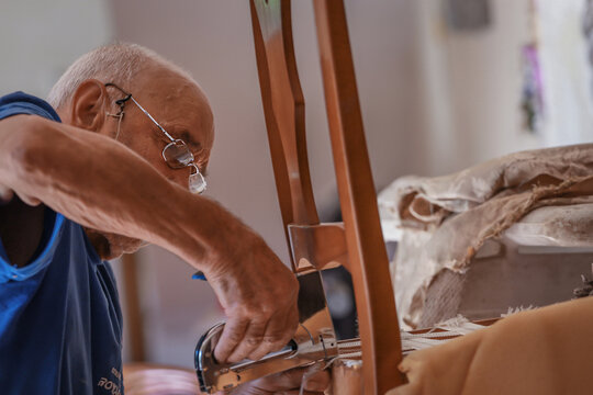 upholsterer craftsman working in the workshop