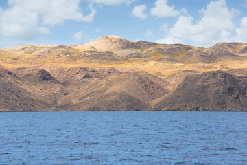 Uninhabited inhospitable island without trees, houses or roads -