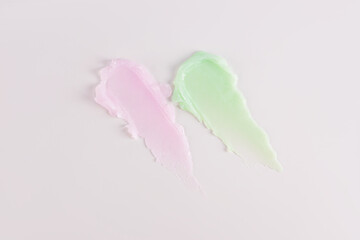 multicolored smeared lip balm samples on a white background. Cosmetic texture sample. delicate pastel texture colors. Layout for presentation.
