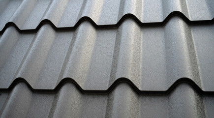 Close-up view lightweight galvanised steel roofing sheet. Modular tile effect roof panel. Traditional metal shingle tiles. Popular profiled metallic pantile mimic clay or concrete slate © JinOdin