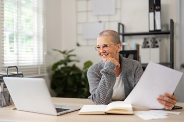 Naklejka premium Senior Woman Managing Bills and Finances at Home with Laptop and Documents in Modern Home Office