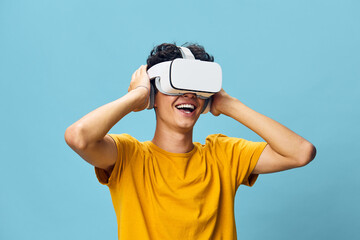 Virtual Reality, Technology, Joy, Youth, Excitement, Fun, Modern, Experiences, Innovation, Entertainment, Engagement, Blue Background, Smiling Person, VR Headset, Hands Up, Happy Expression