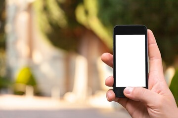 Hand holding smart phone with blank screen