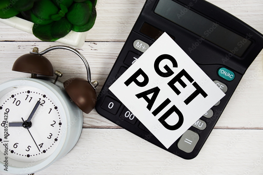 Poster time to get paid text message with calculate and alarm clock top view on wooden background