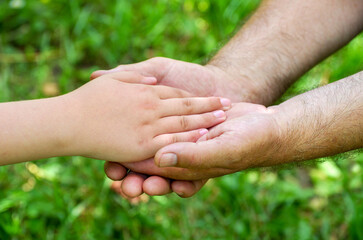 hands of young child and old senior