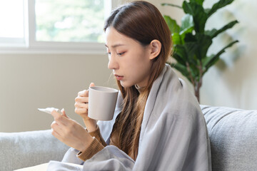 Woman measuring temperature her body on the bed. person got fever lying on the bed