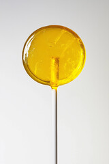 Bright Yellow Lollipop on White Stick