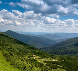 landscape with the valley of the Chornohirsky ridge in summer, vacation in Ukraine. Carpathian mountains with silhouettes of distant peaks