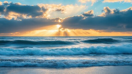 Obraz premium A serene seascape at sunset with rays of light breaking through clouds over gentle waves.