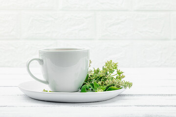 Lemon balm tea on white wooden background. Fresh edible herbs, trendy drink. Organic healthcare