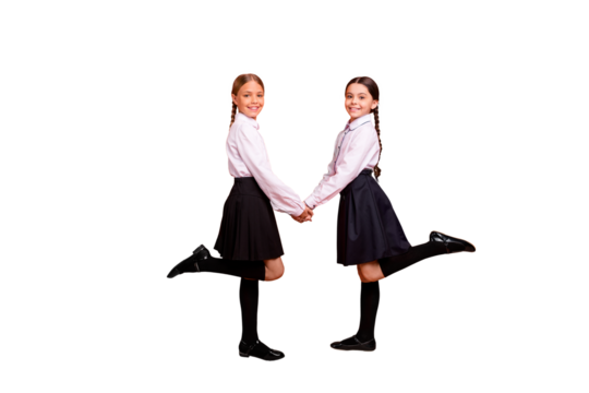 Full length body size profile side view of two person nice attractive charming cute cheerful pre-teen girls holding hands having fun pause break isolated over bright vivid shine orange background