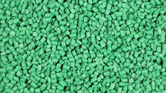 Polymer granules and plastic granules green color that spin on themselves