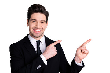 Close up photo amazing toothy he him his macho attractive handsome hand arm index finger direct indicate empty space wear white shirt black suit jacket tie formal-wear isolated bright grey background